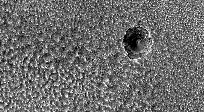 A Crater Enlarged by the Sublimation of Ice
